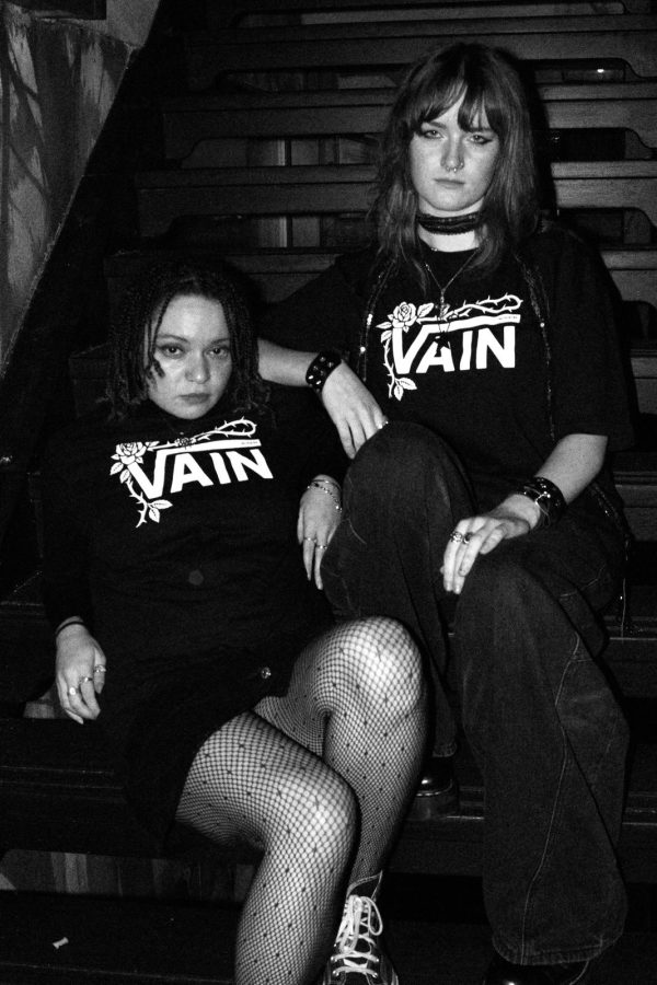 No Poetry black VAIN streetwear tee worn on stairs in low light.