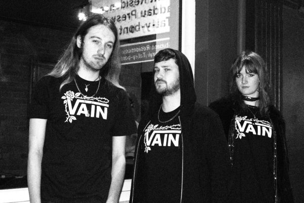 No Poetry black VAIN skatewear tee worn by a group outside at night